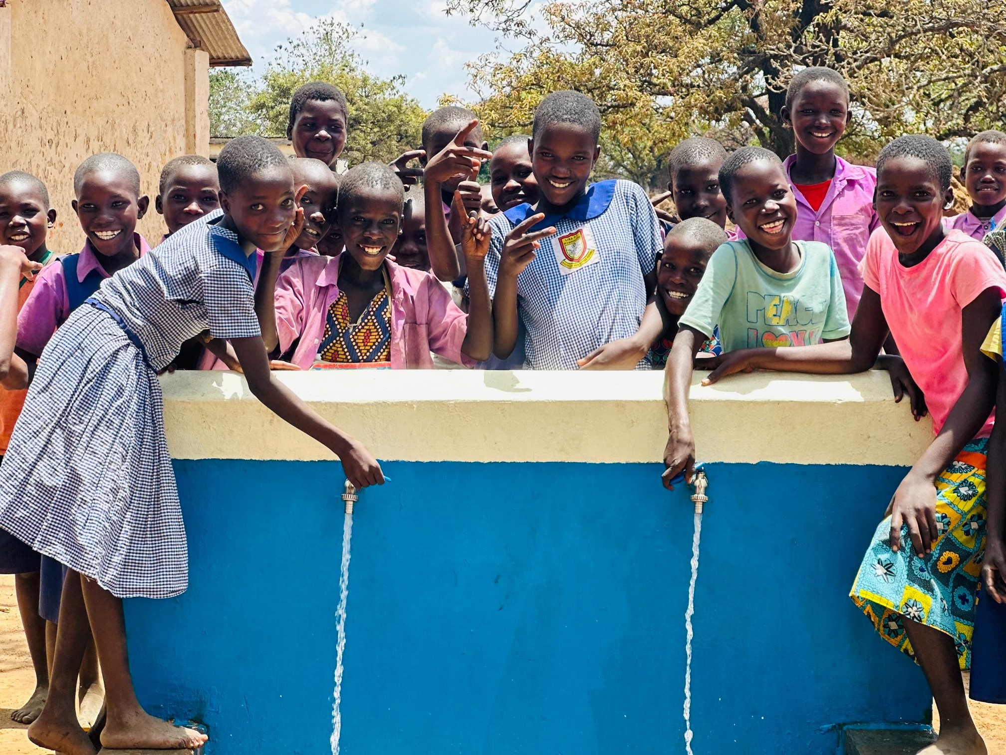 Children gathering around a clean water point at Abalo Primary School