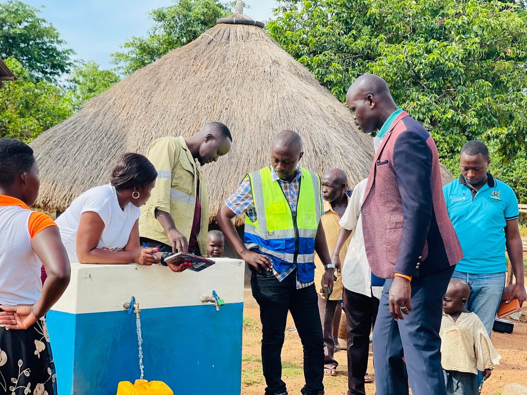Community members inspecting a water point